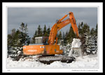 Hitachi backhoe building a Ski-doo jumping ramp.